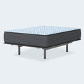 Side view of the 15 inch Destin Cove Firm Mattress on a metal frame with textured grey side panels.