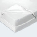 Corner view of the Orion 2-Stage Crib & Toddler Mattress with its removable organic cover.