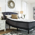 Ashley Sierra Sleep 12 Inch Plush Mattress inclined on an adjustable base for reading or elevated sleeping.
