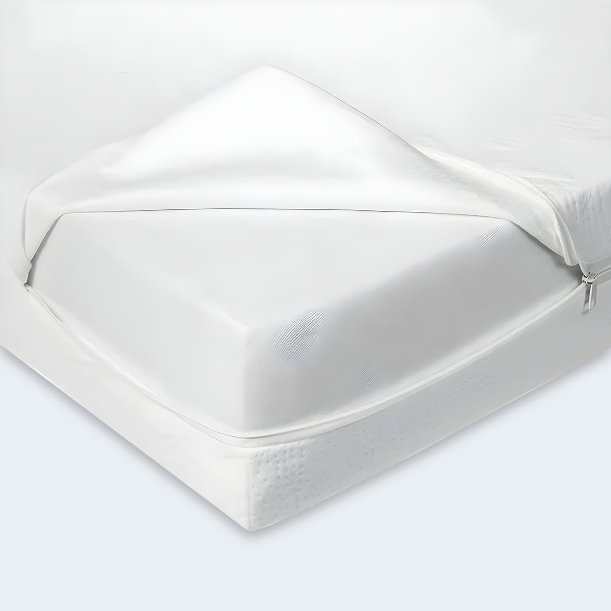 Corner view of the 5 inch organic mini crib mattress with the outer cover partially removed.