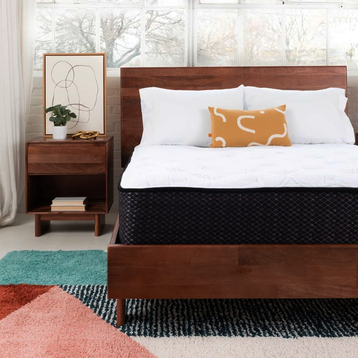 Sierra Sleep Limited Edition Firm Mattress positioned on a dark wooden bed frame in a master bedroom.