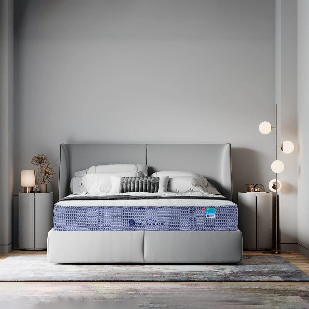 Modern minimalist bedroom featuring the Americanstar Bluesky 11-inch firm mattress styled on a grey upholstered platform bed frame.
