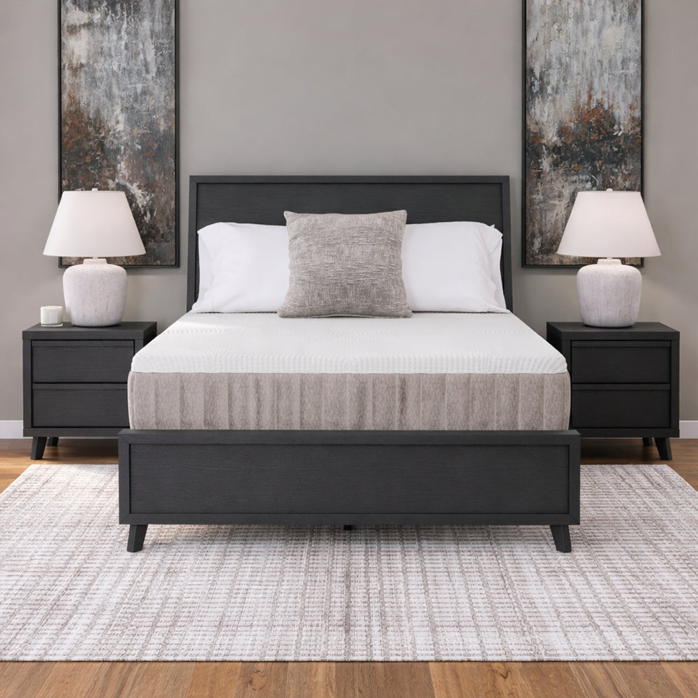 Frontal symmetrical bedroom shot featuring the Ashley Furniture Terra Sleep 12-inch hybrid mattress styled on a black platform frame for superior back support.
