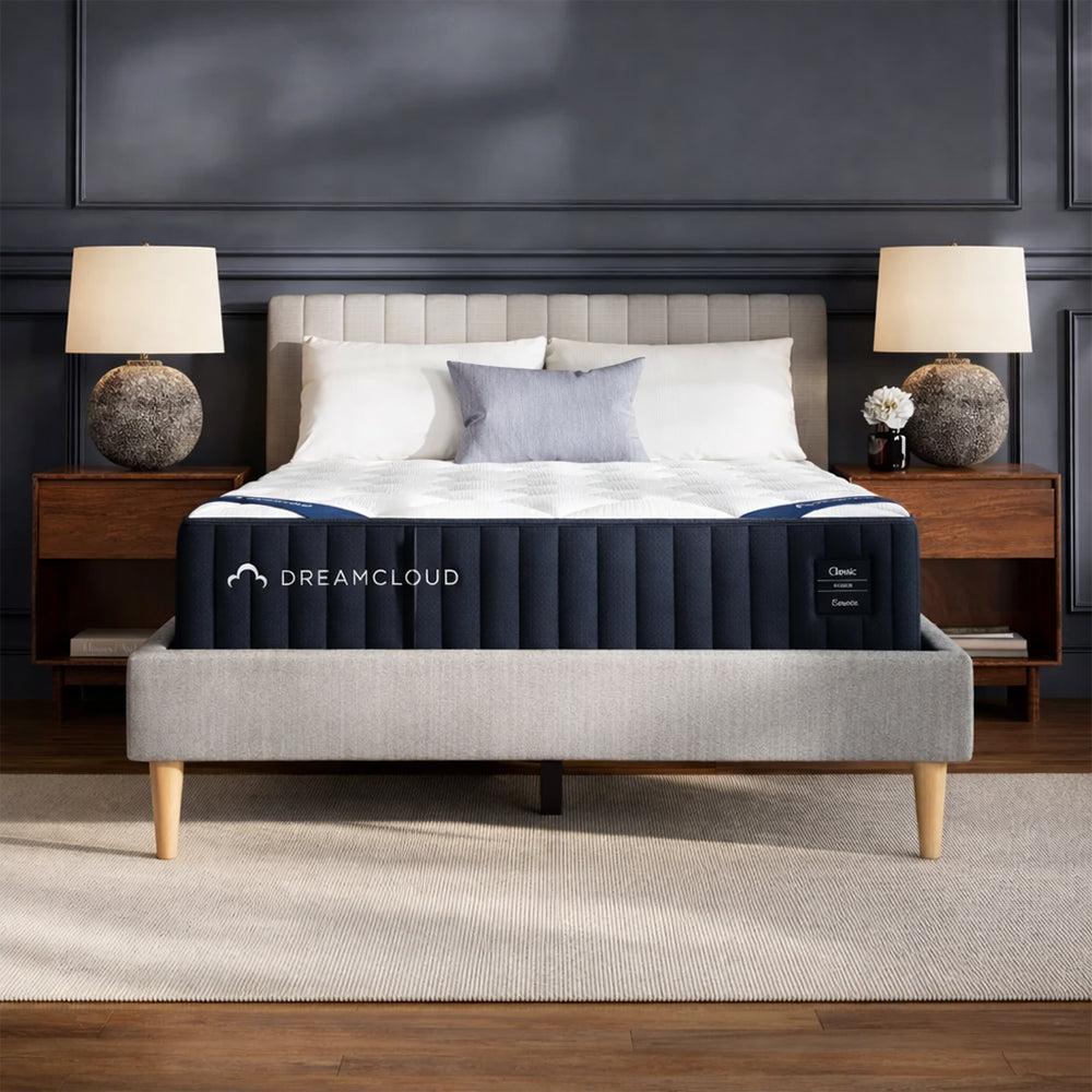 Symmetrical frontal view of the DreamCloud Classic 12" Medium Firm Mattress in a contemporary master bedroom with designer furniture.