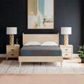 Symmetrical frontal view of the Hot Buy 13 Inch Firm Hybrid Mattress by Ashley styled in a modern master bedroom with a light wood bed frame.
