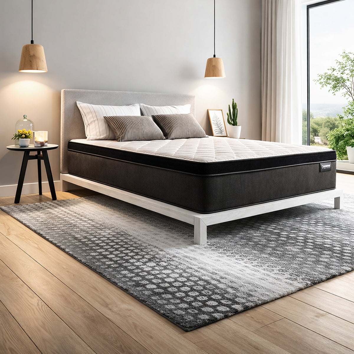 Drift Euro Top Mattress in bedroom setting on a white platform bed frame with striped pillows and lamps.