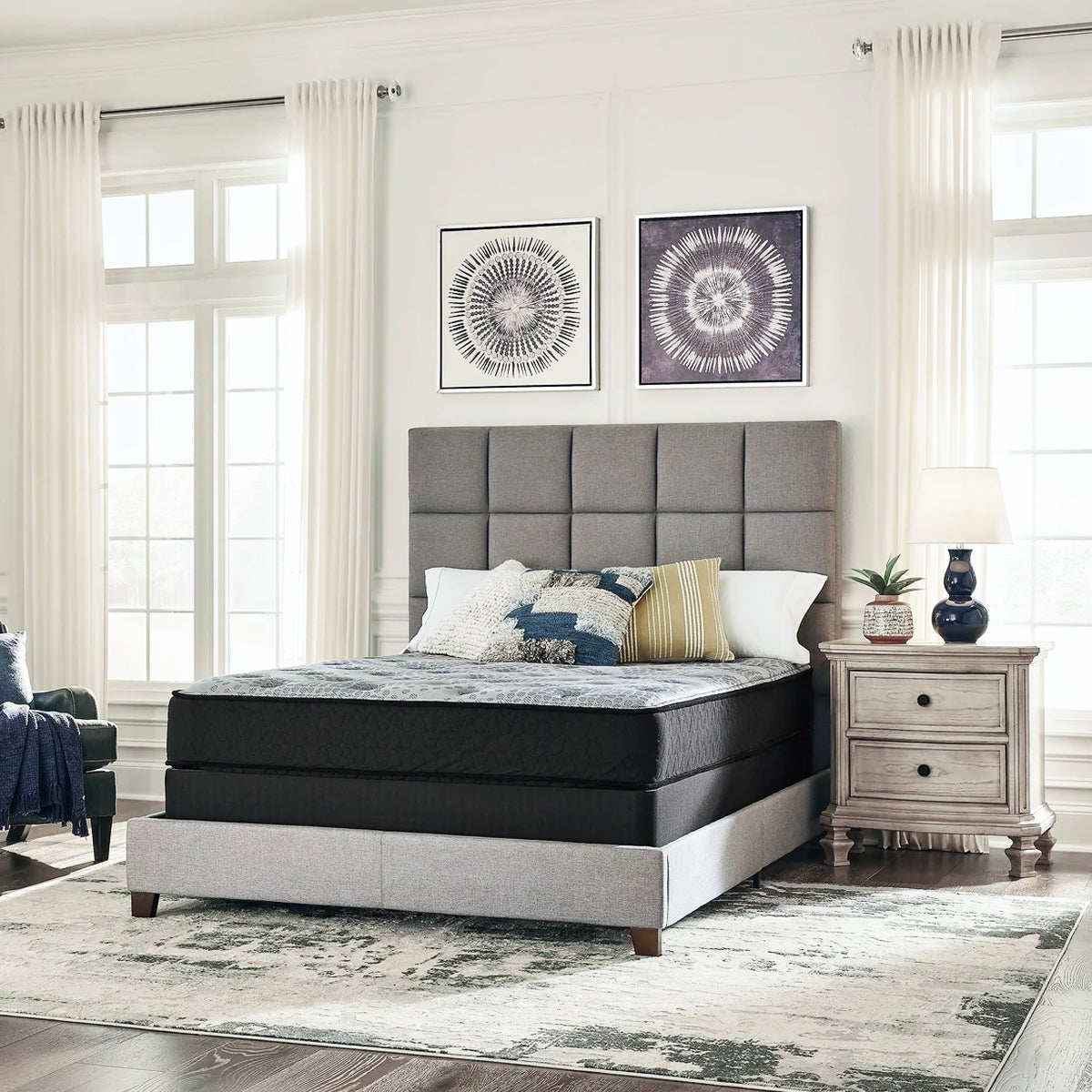 Comfort Plus 10 Inch Medium Mattress in a bedroom setting with modern art and light grey upholstered furniture.