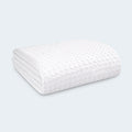 Close-up of the pebble pattern on a BEDGEAR Dri-Tec Kids Mattress Protector fitted securely over a white mattress.