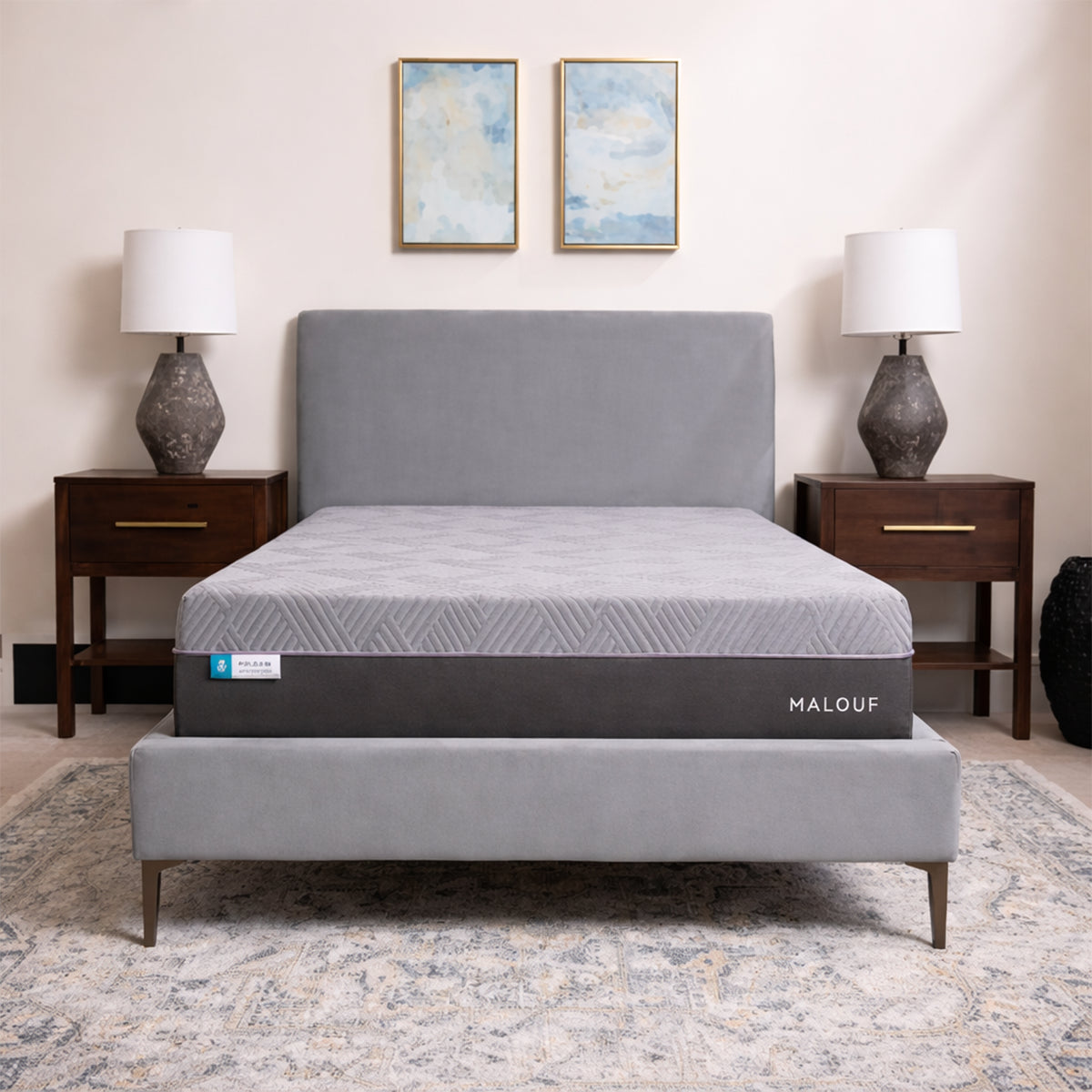 Full front view of the Polaris 12" Coolsync Hybrid Mattress on a grey bed frame centered in a bright, decorated bedroom.