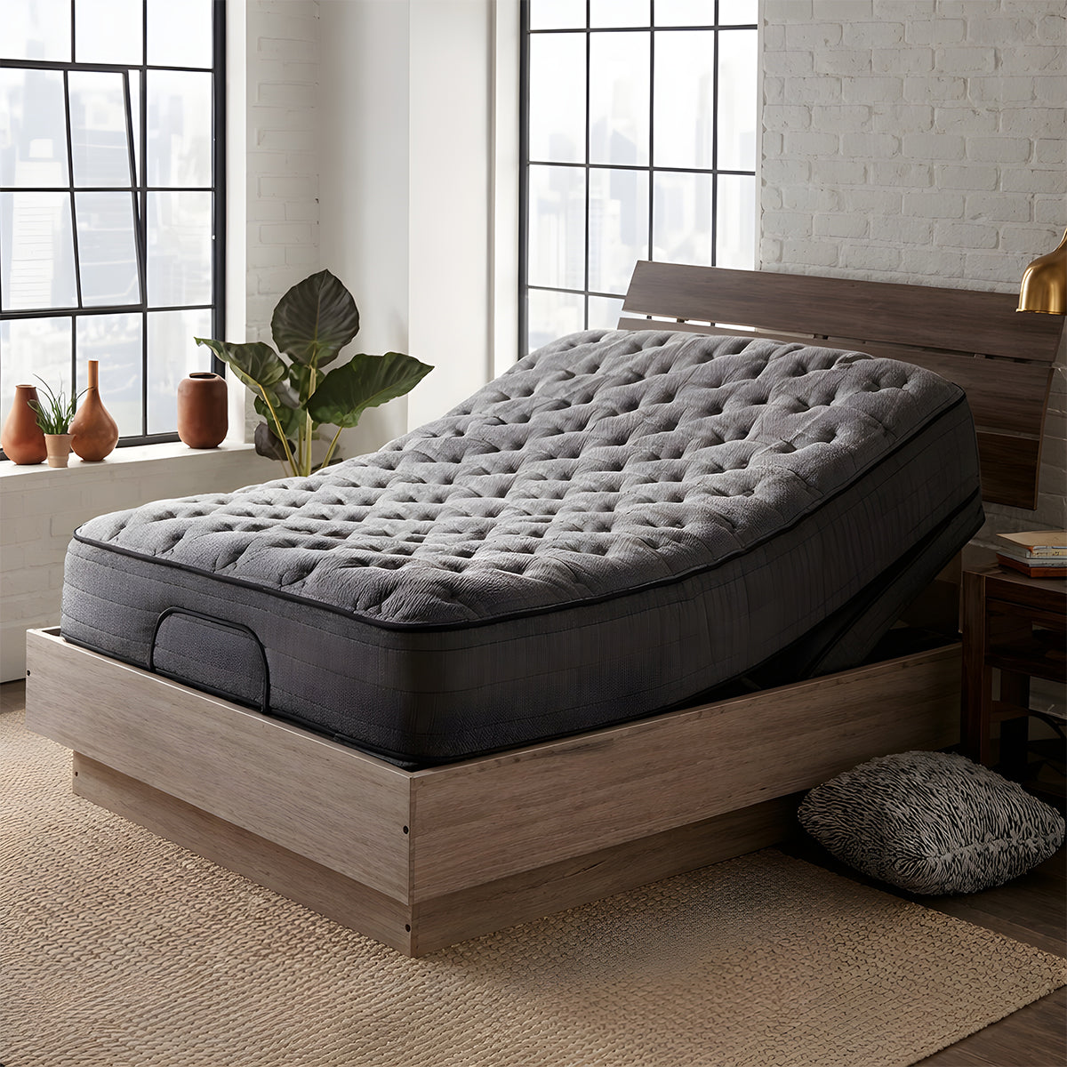 Corsicana Nights Bridge 12-inch firm hybrid mattress displayed on an adjustable wooden platform bed frame with the head section elevated.
