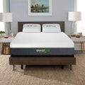 Luxury bedroom setting showcasing the GhostBed Elite 12-inch cooling mattress styled on a mid-century modern wooden bed frame.
