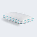 Malouf FlexFill pillow with HyperChill cooling cover tilted on a white modern bed for hot sleepers.
