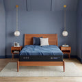 Serta iSeries NXG 3500 13.5 inch firm hybrid mattress in a modern bedroom with cooling cover.
