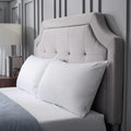 Pair of white Malouf Prime pillow protectors on a modern bed for a clean, professional look.
