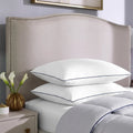  Stacked SleepTone Loft feather and down pillows on a bed for a supportive and hotel-quality sleep experience.