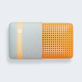 Top-down view of the Vitality Memory pillow showing the perforated orange foam and gray padded cooling cover.
