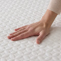 Soft, textured cooling fabric of the Malouf HyperChill mattress protector for temperature-regulated sleep.
