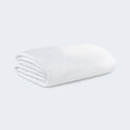 Folded BEDGEAR Stretchwick mattress protector made with high-stretch, moisture-wicking cooling fabric.
