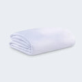 Folded white BEDGEAR Stretchwick mattress encasement featuring high-stretch, moisture-wicking fabric.
