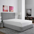 Sleek, waterproof SleepTone mattress protector on a queen bed in a modern bedroom for a fresh sleep environment.

