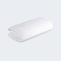Folded BEDGEAR Dri-Tec crib mattress protector showing moisture-wicking fabric for a dry and cool baby nursery.
