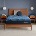 Serta iSeries NXG 4500 13.5" ultra plush memory foam mattress on a modern wooden bed frame.
