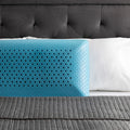 Ergonomic blue cooling gel memory foam pillow on a bed, designed for superior neck and head support.
