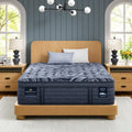 Serta Perfect Sleeper Pro Valais 15 inch latex hybrid plush pillow top mattress on a wooden bed frame.
