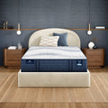 Serta iComfortPro Kingston 14 inch firm latex mattress on a contemporary bed frame in a styled bedroom.