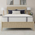 Frontal view of the South Bay Sofinity Hybrid Signature 12-inch firm mattress featuring navy blue piping on a contemporary rattan platform bed.
