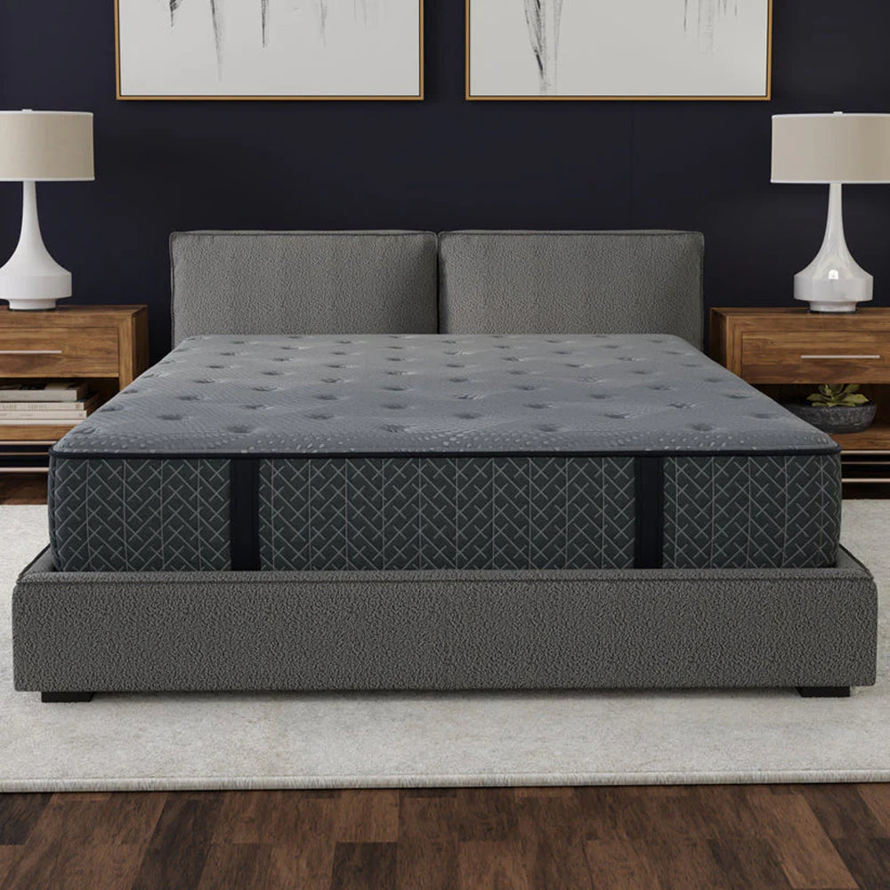 Front view of the Allureluxe™ Bamboo Hybrid 10-inch medium-firm mattress on a grey upholstered bed in a contemporary bedroom.
