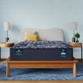 Serta Perfect Sleeper X Quilted Hybrid Knox Firm 13.5 Inch Mattress on a modern wood bed frame.

