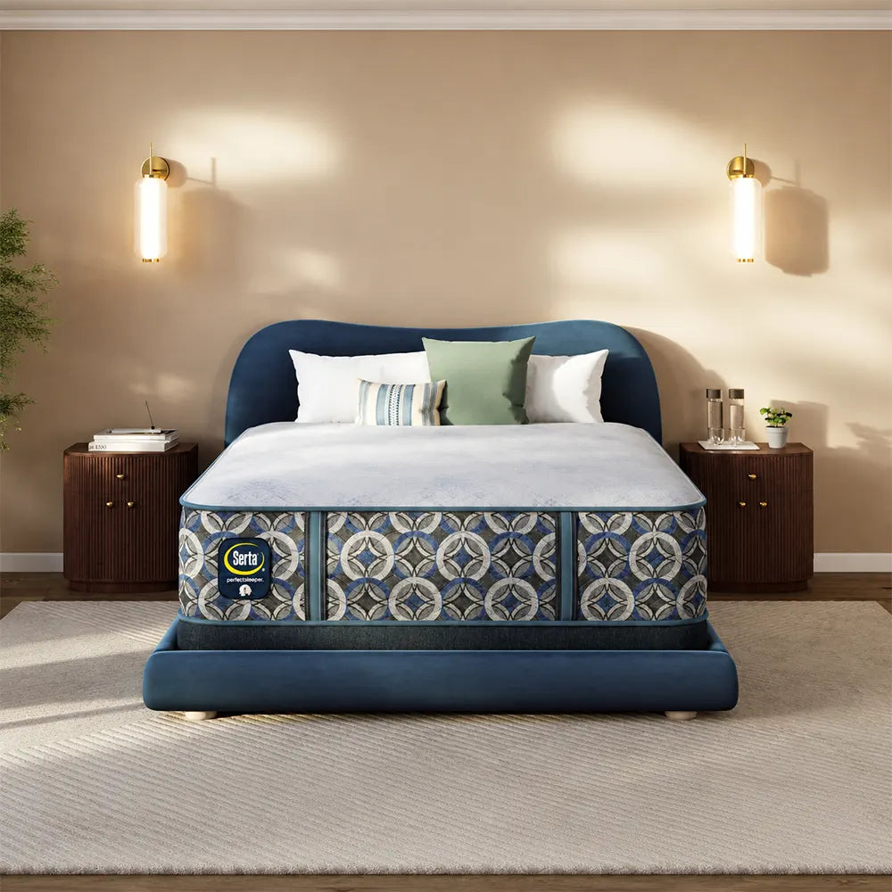 Serta Perfect Sleeper Cascade Bluff Hybrid Firm 14.5 Inch Mattress on a luxury blue upholstered bed.
