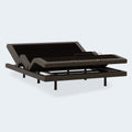 Perspective view of the Comfort Ultra Adjustable Base by Ashley with head and foot sections raised for ergonomic support.

