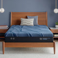 Serta iSeries NXG 1500 12 inch Hybrid Firm mattress on a wooden platform bed in a modern bedroom.
