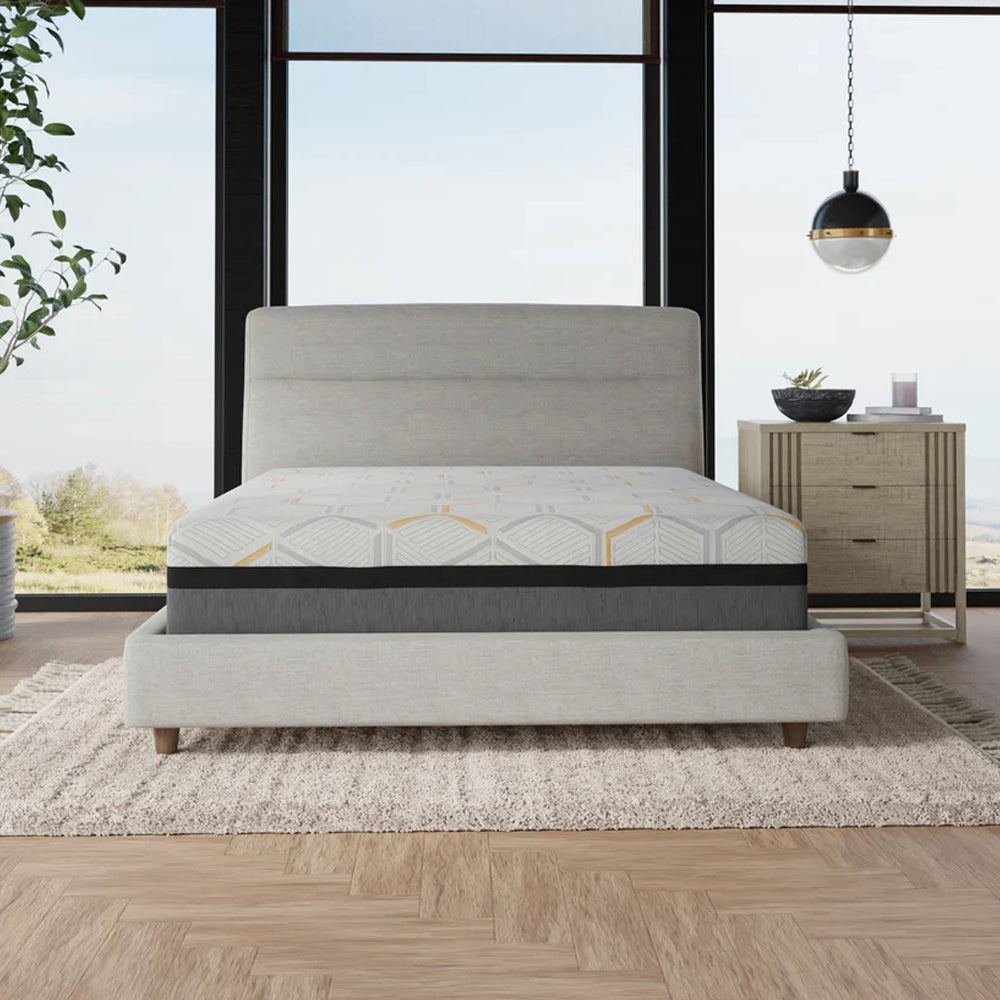 Front view of the South Bay 14-inch hybrid copper-gel memory foam mattress on a light grey upholstered platform bed in a modern master bedroom.

