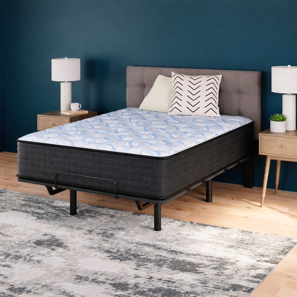 Modern master bedroom featuring the Ashley Elite Springs 14-inch firm mattress on a grey upholstered platform bed against a teal accent wall.
