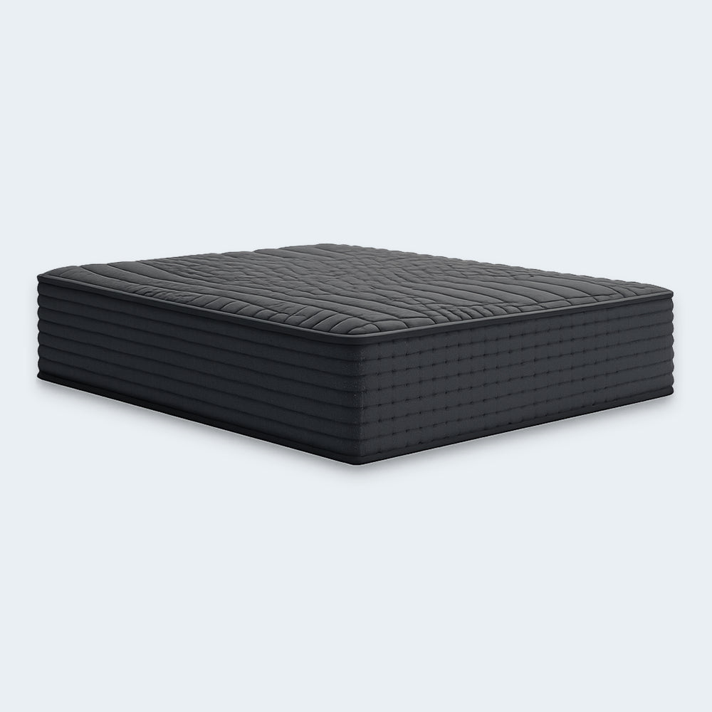 Three-quarter view of the Gray 1200 Hybrid firm mattress by Ashley, engineered for back and stomach sleepers needing firm support.

