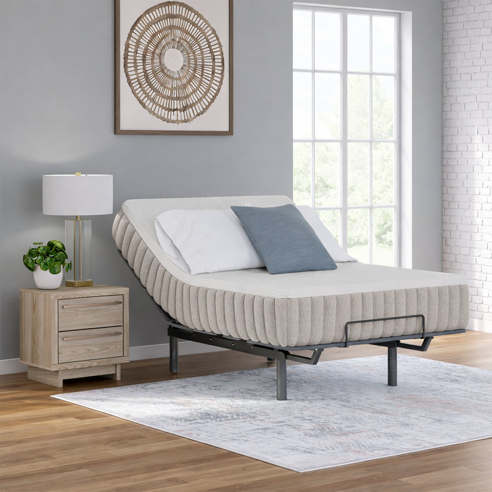 Luxury bedroom setting with the Terra Sleep 12" mattress elevated on an adjustable base, showcasing a modern sleep system in a designer interior.