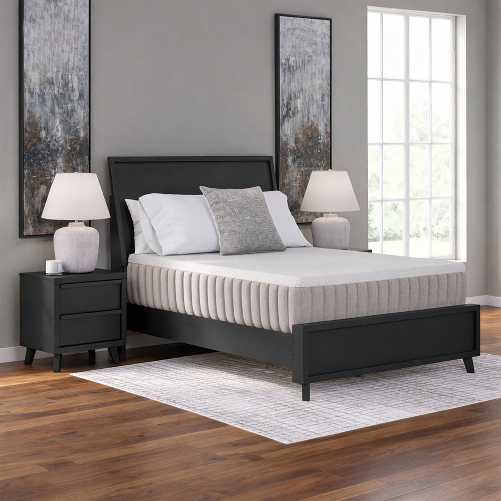 Symmetrical frontal bedroom view of the Ashley Terra Sleep 12-inch mattress elevated on a power base for ergonomic reading and sleeping positions.
