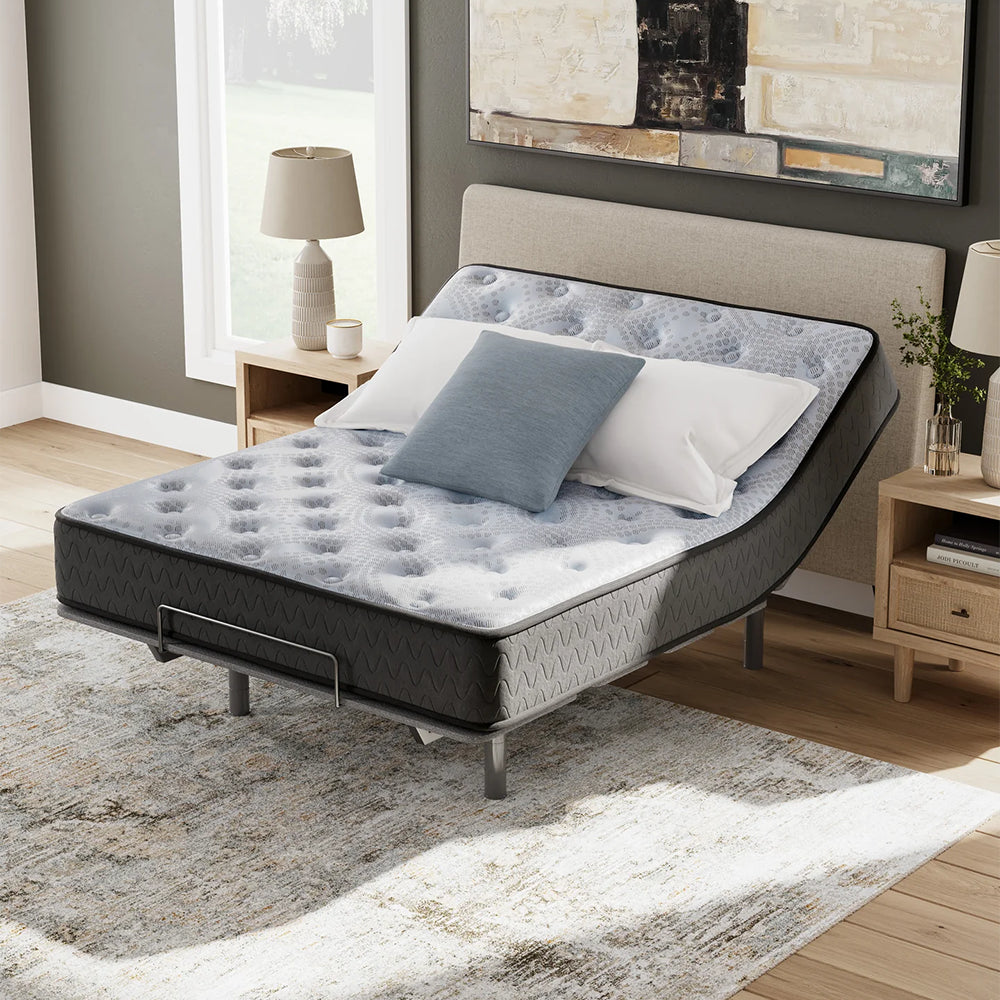 Luxury bedroom setting with the Comfort Plus 10-inch medium mattress elevated on a power base, optimized for ergonomic sleep.