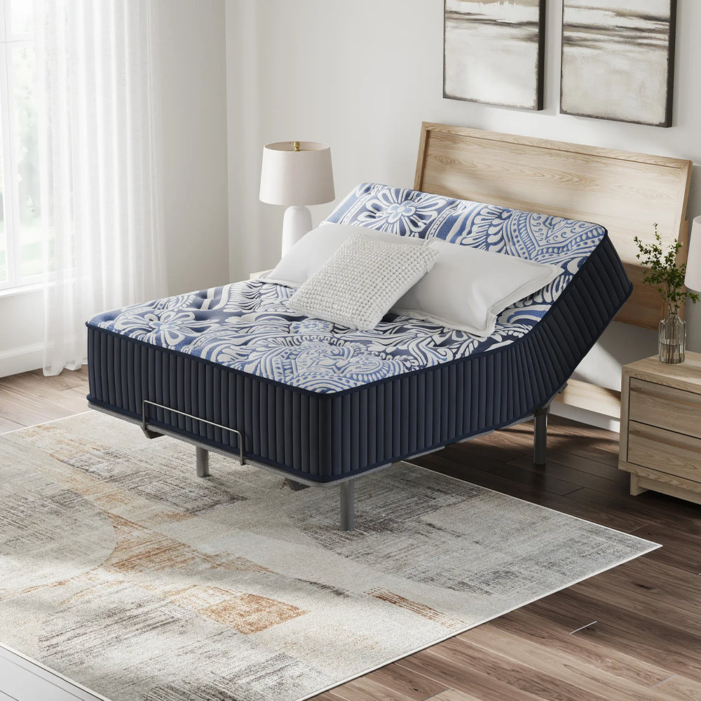 Ashley Luxe 2.0 Blue mattress with the head section raised on an adjustable base in a luxury minimalist bedroom setting.

