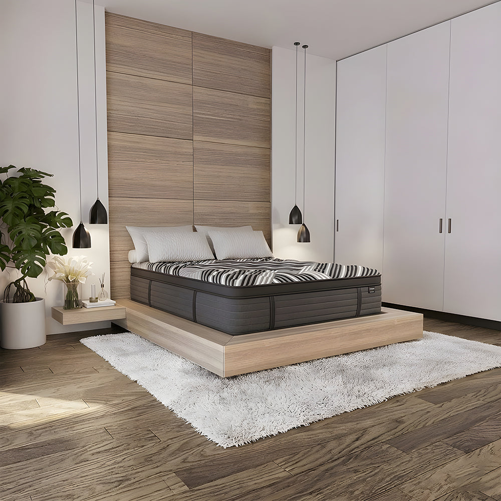 Luxury modern bedroom setting with the 15-inch Dreamstage 2.0 Calm Quilted mattress styled on a minimalist light wood platform bed frame.
