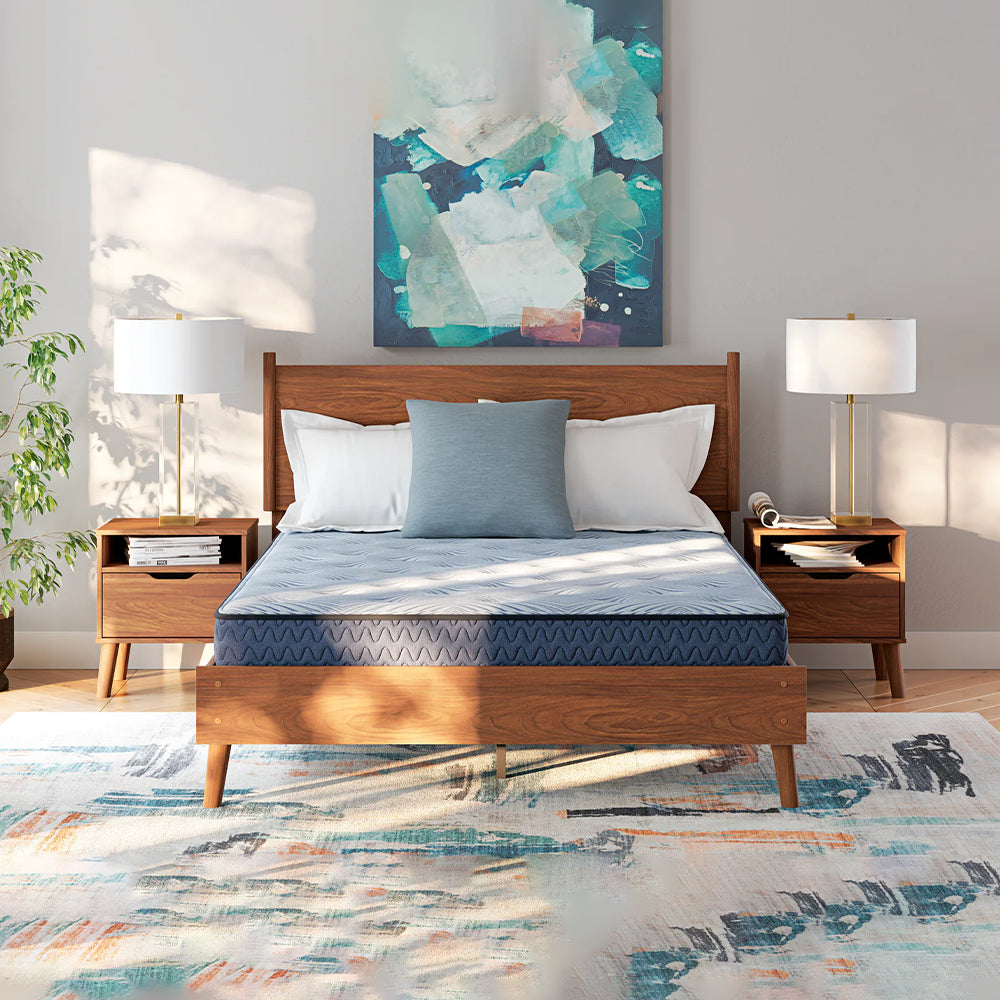 Symmetrical front-facing bedroom view of the Peak 2.0 8-inch mattress styled on a mid-century modern wooden platform bed frame.
