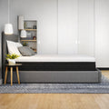 Side view of the Response Copper 12 inch mattress in a minimalist bedroom with neutral decor and lighting.
