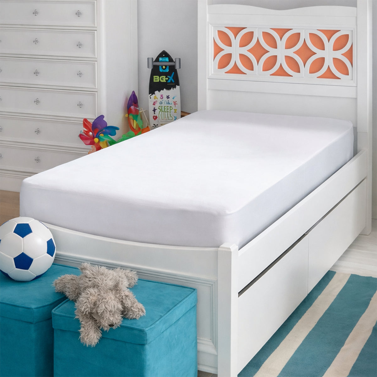 Side angle view of the Basic Kids Mattress Protector fitted on a twin bed in a kids room with blue storage ottomans.