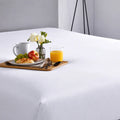 Stain-resistant SleepTone SmartGuard mattress protector offering waterproof protection for enjoying breakfast in bed.
