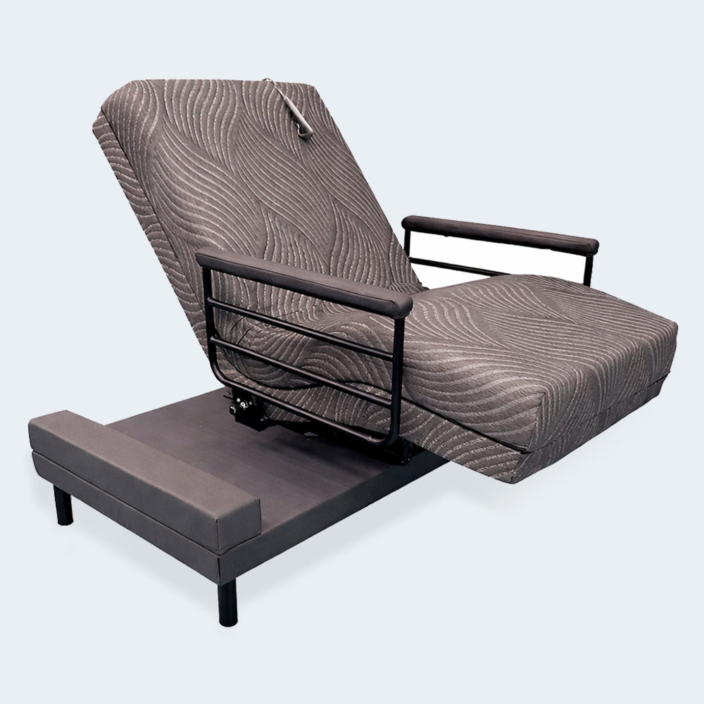 The Independence motorized lift bed in a semi-reclined lounge position featuring grey wave-patterned upholstery.
