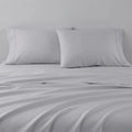 Soft grey Hyper-Cotton pillowcases on breathable bed sheets for ultimate comfort.
