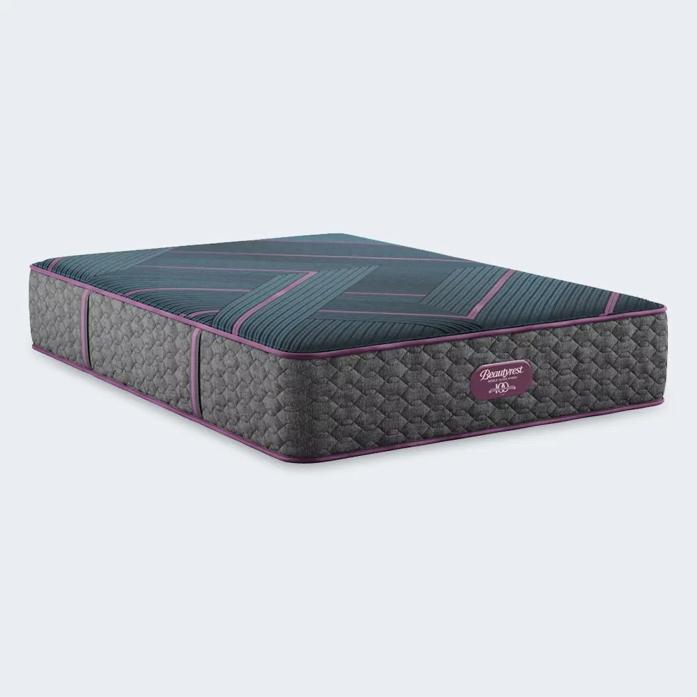 Hand pressing on Beautyrest World Class Hybrid mattress to show responsive medium support and pressure relief.
